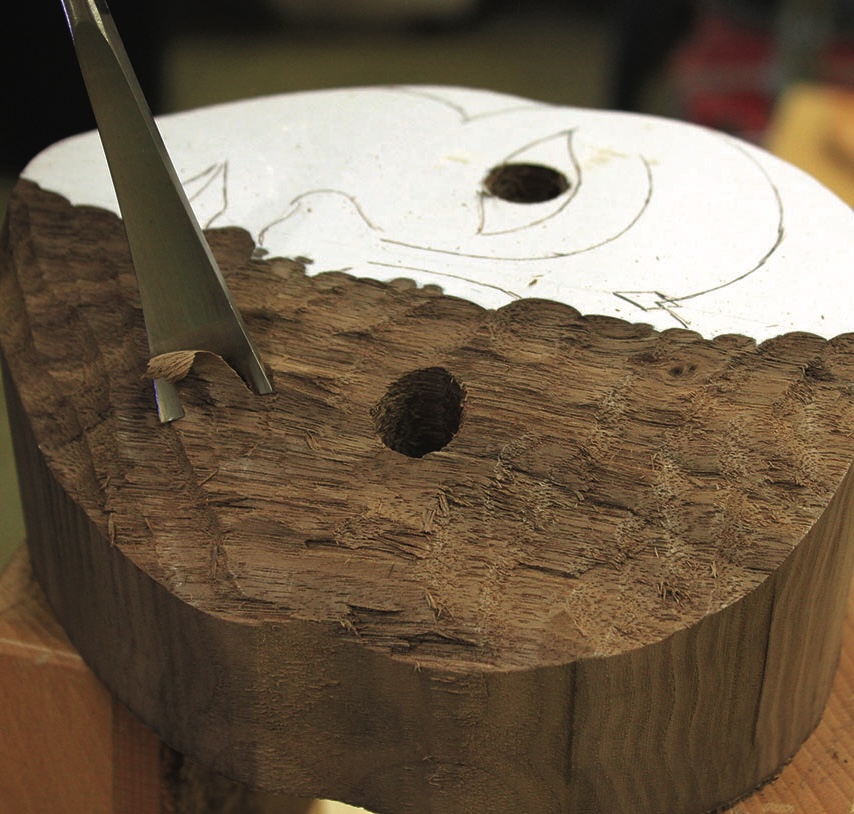 Carving wood with chisel and holes for screws.