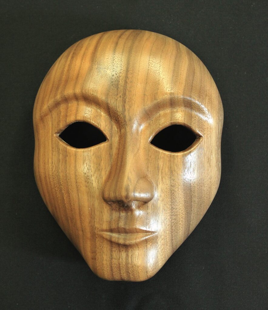 Wooden mask on black background