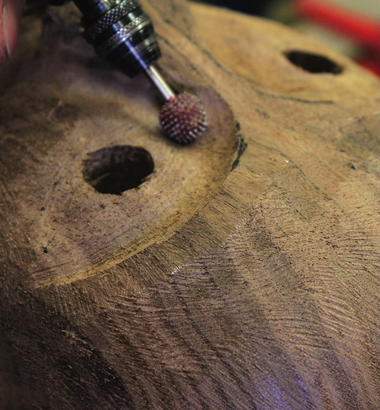 Detailed wood carving with rotary tool.
