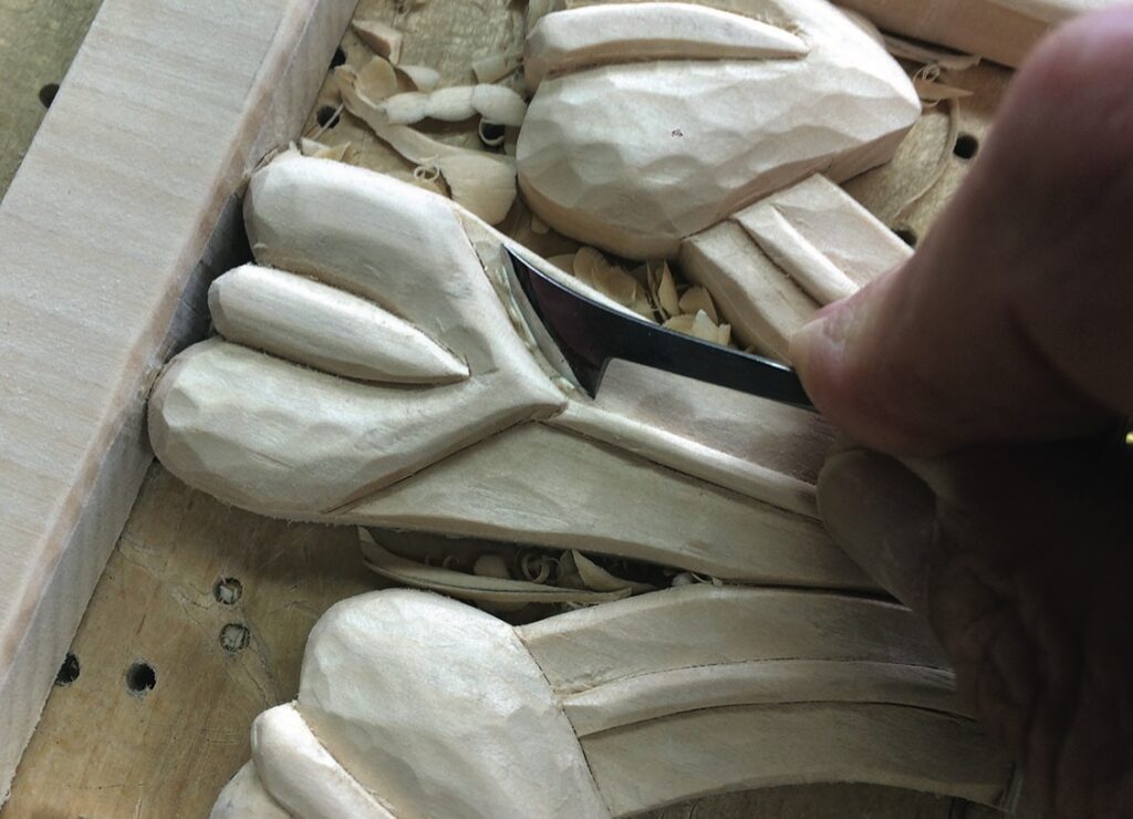 Close-up of intricate wood carving in progress.