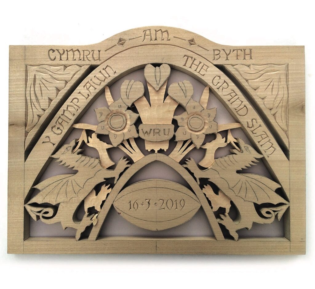 Welsh wooden carving with dragons and flowers, 2019.