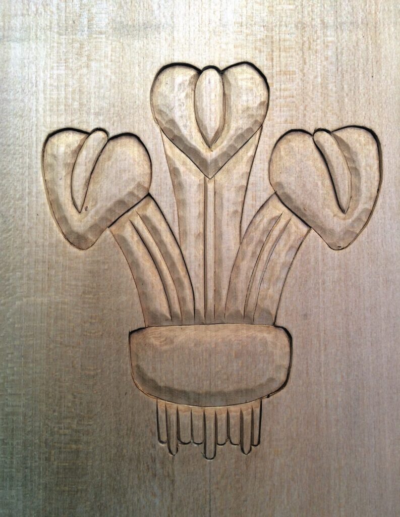 Carved wood floral design on wooden surface.