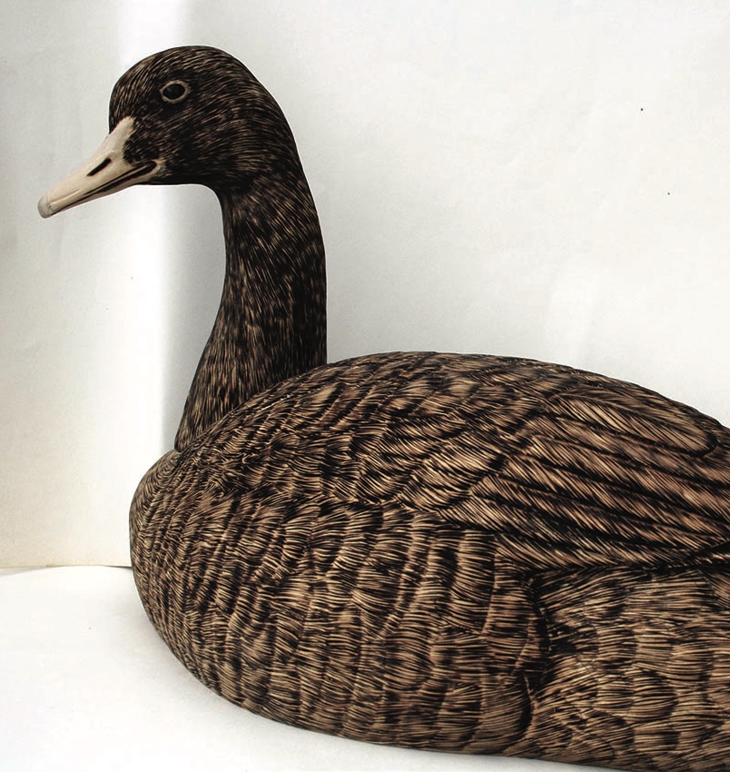 Intricate wood duck decoy with brown feather pattern.
