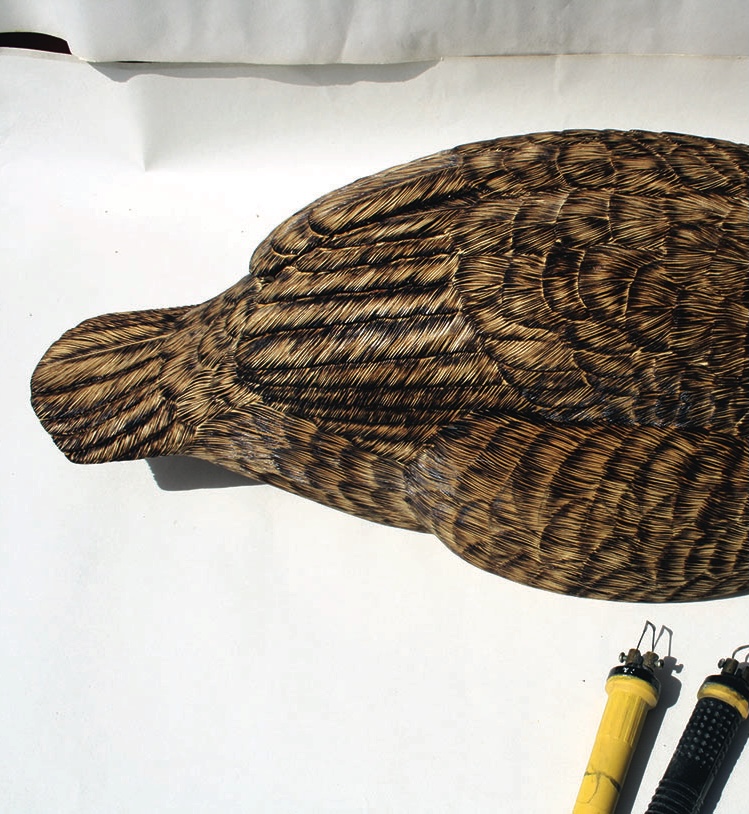 Carved wooden bird on white background