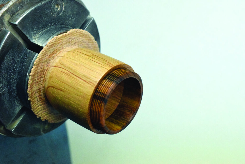 Woodturning chuck holding a wooden piece