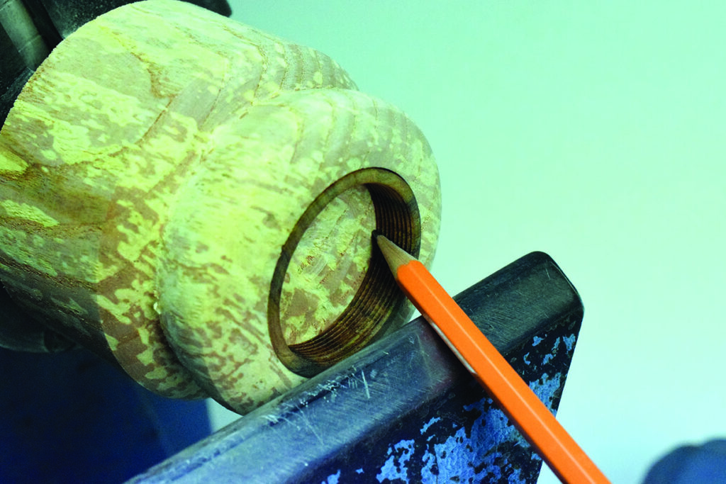 Marking wood centre with pencil for turning