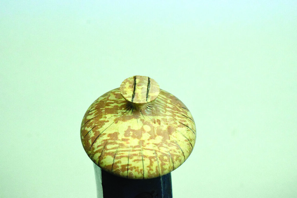 Close-up of intricate wooden sword handle design.