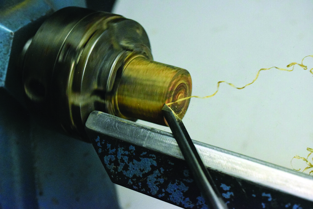 Turning wood on a lathe with chisel