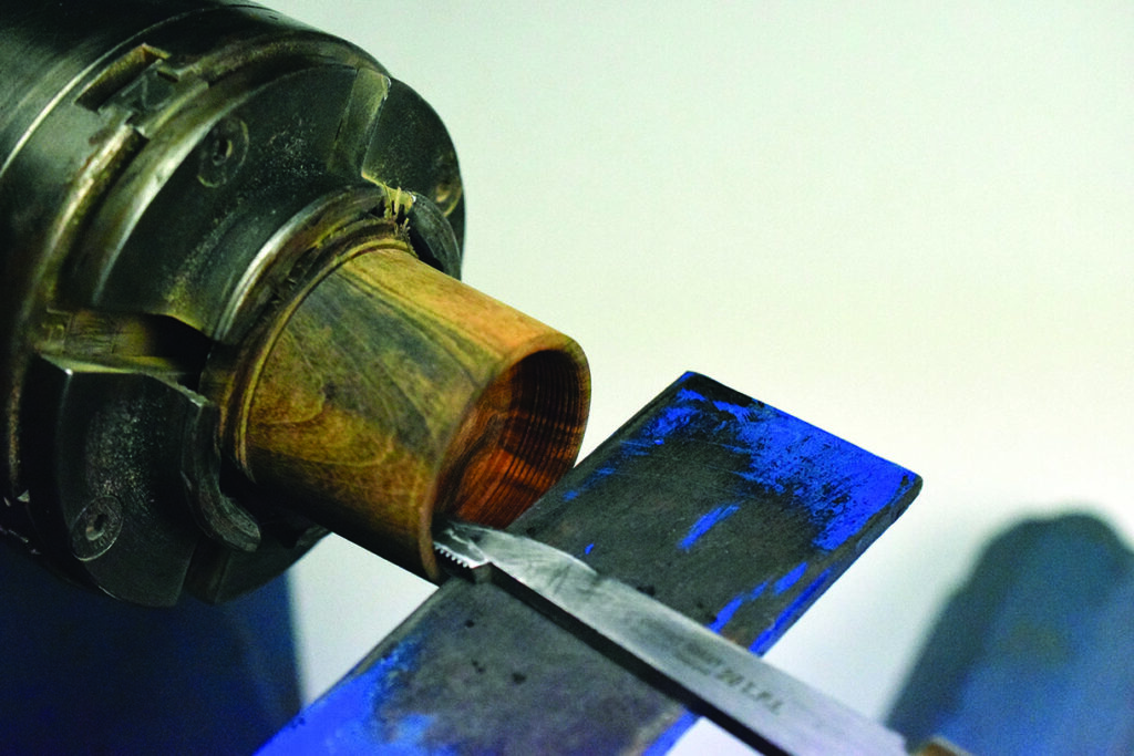 Wood lathe tool sharpening close-up in workshop