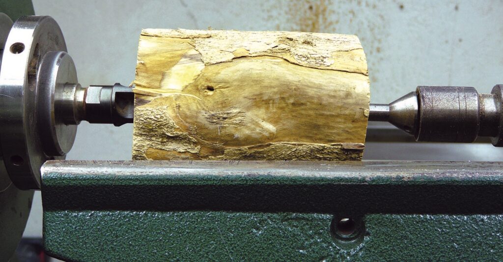 Wood block on a lathe for turning.