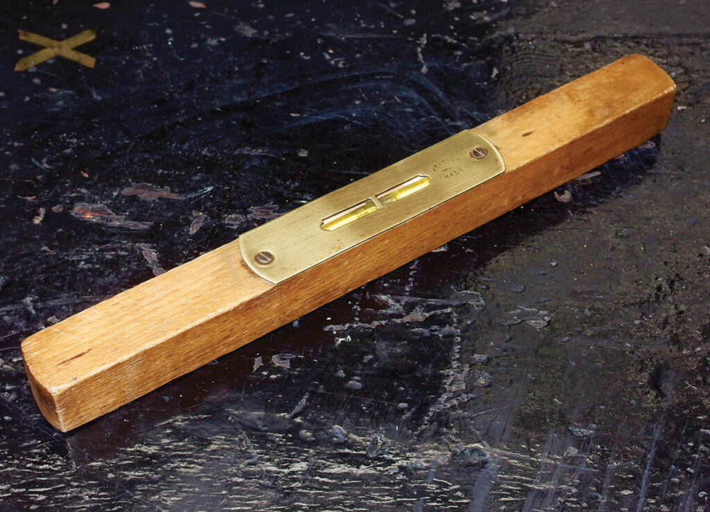 Wooden spirit level on dark surface