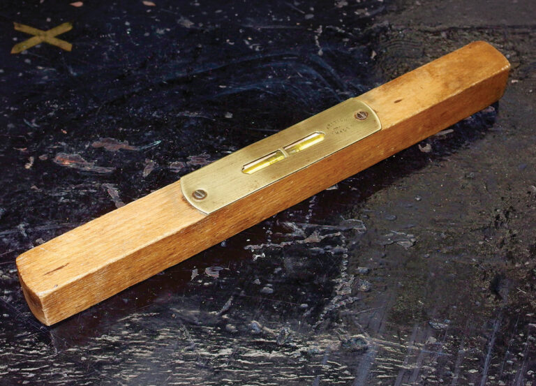 Wooden spirit level on dark surface
