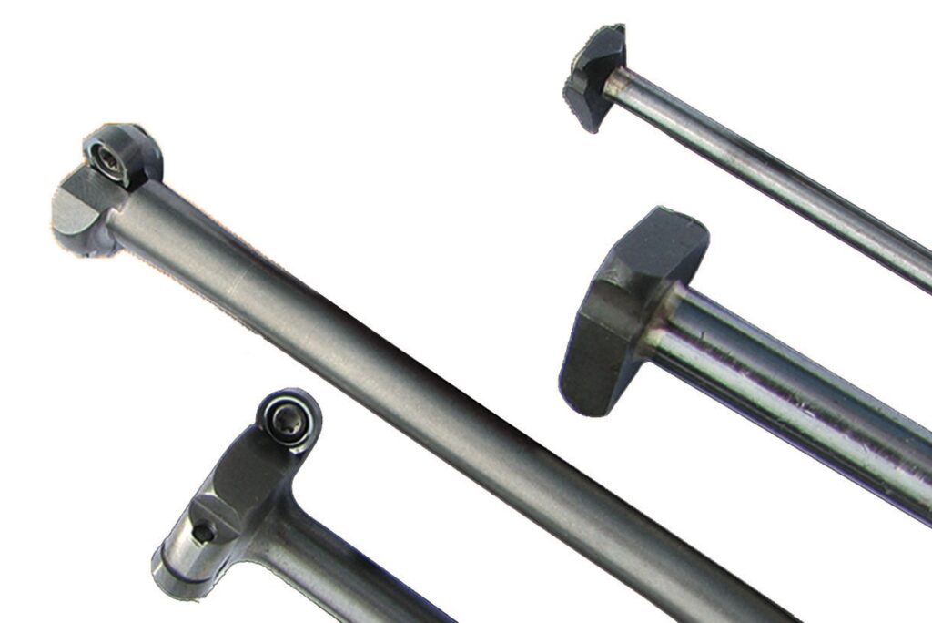 Metallic tool rods with hexagonal heads.
