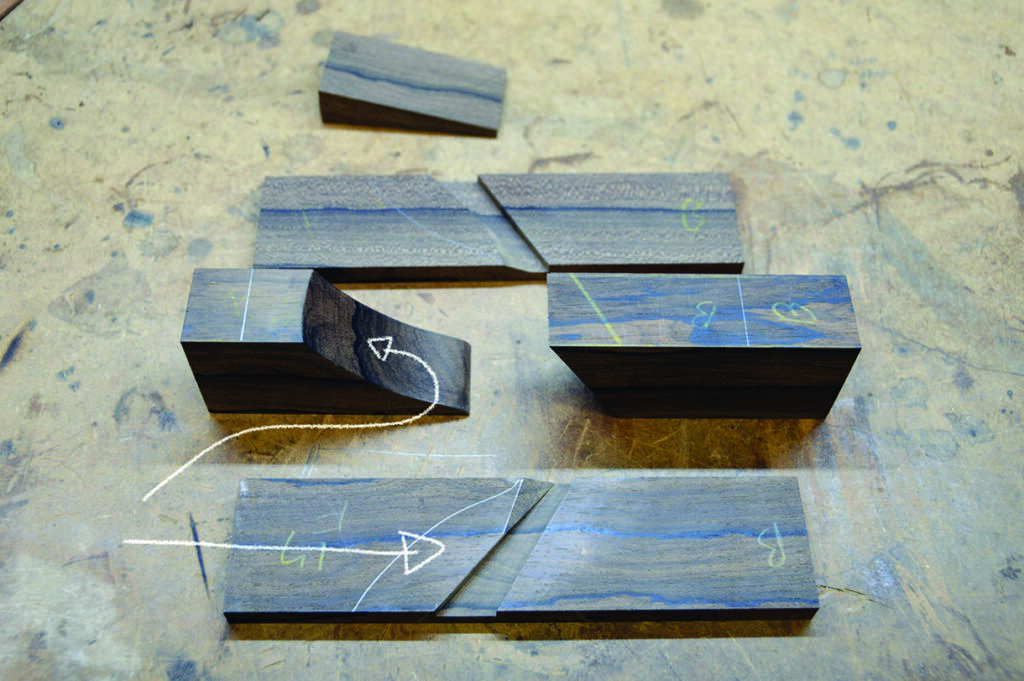 Wooden pieces with chalk markings on workbench.