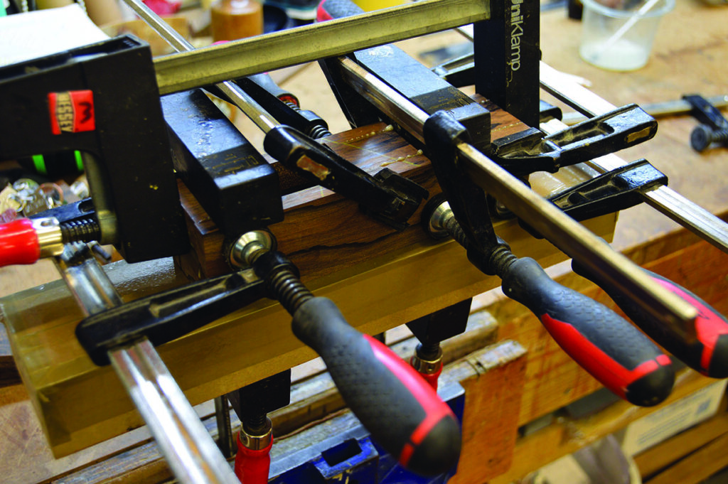Woodwork project clamped on workbench.