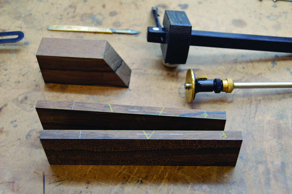 Woodworking tools and marked wood pieces on workbench.