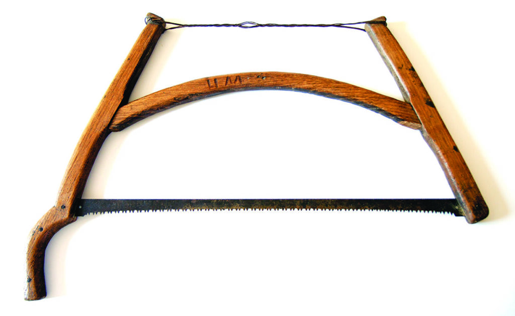 Antique wooden bow saw with metal toothed blade