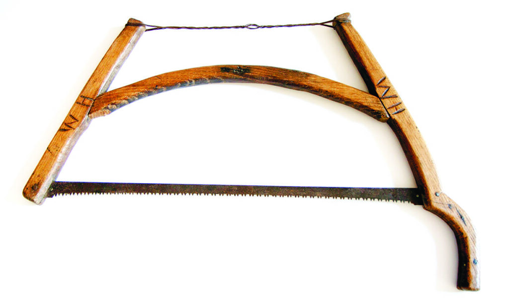 Traditional wooden bow saw with serrated blade