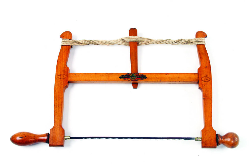 Vintage wooden frame saw with rope tensioning