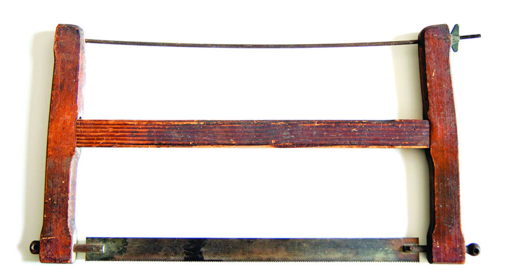 Antique wooden frame saw with metal blade