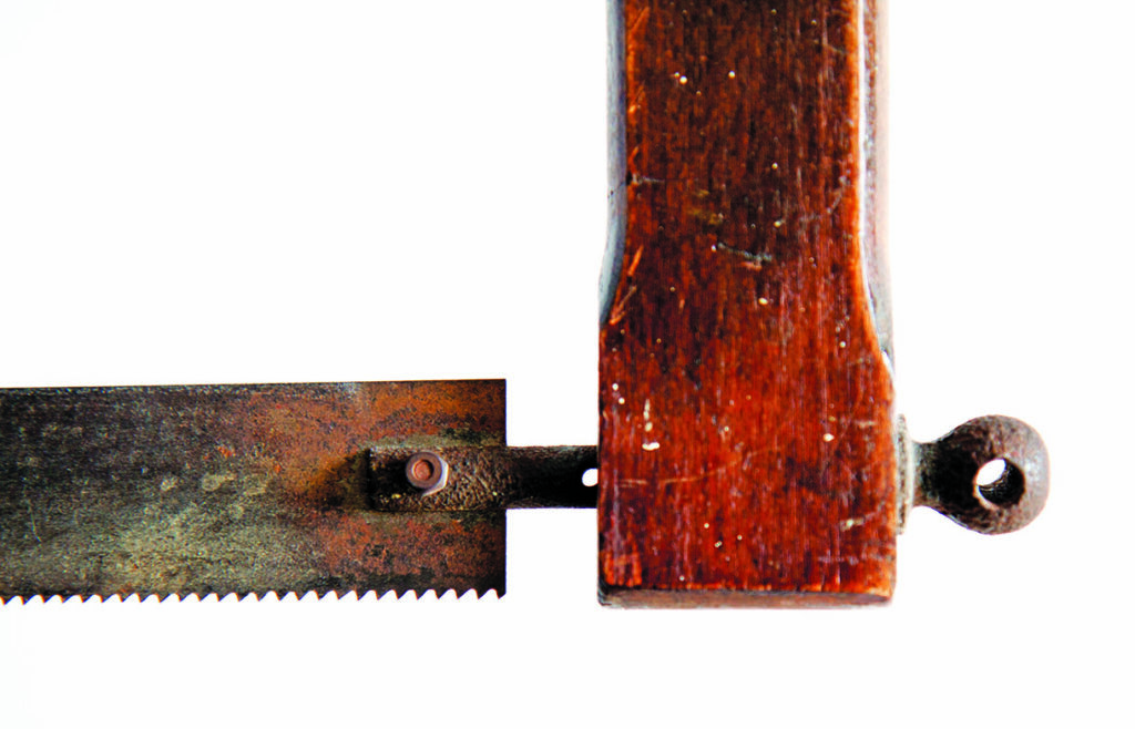 Close-up of vintage hand saw handle and blade
