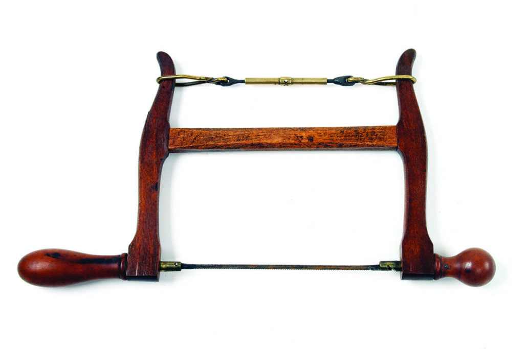 Antique wooden frame saw with brass tensioning mechanism