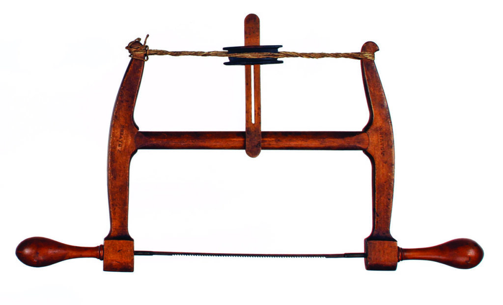 Antique wooden frame saw with rope tension