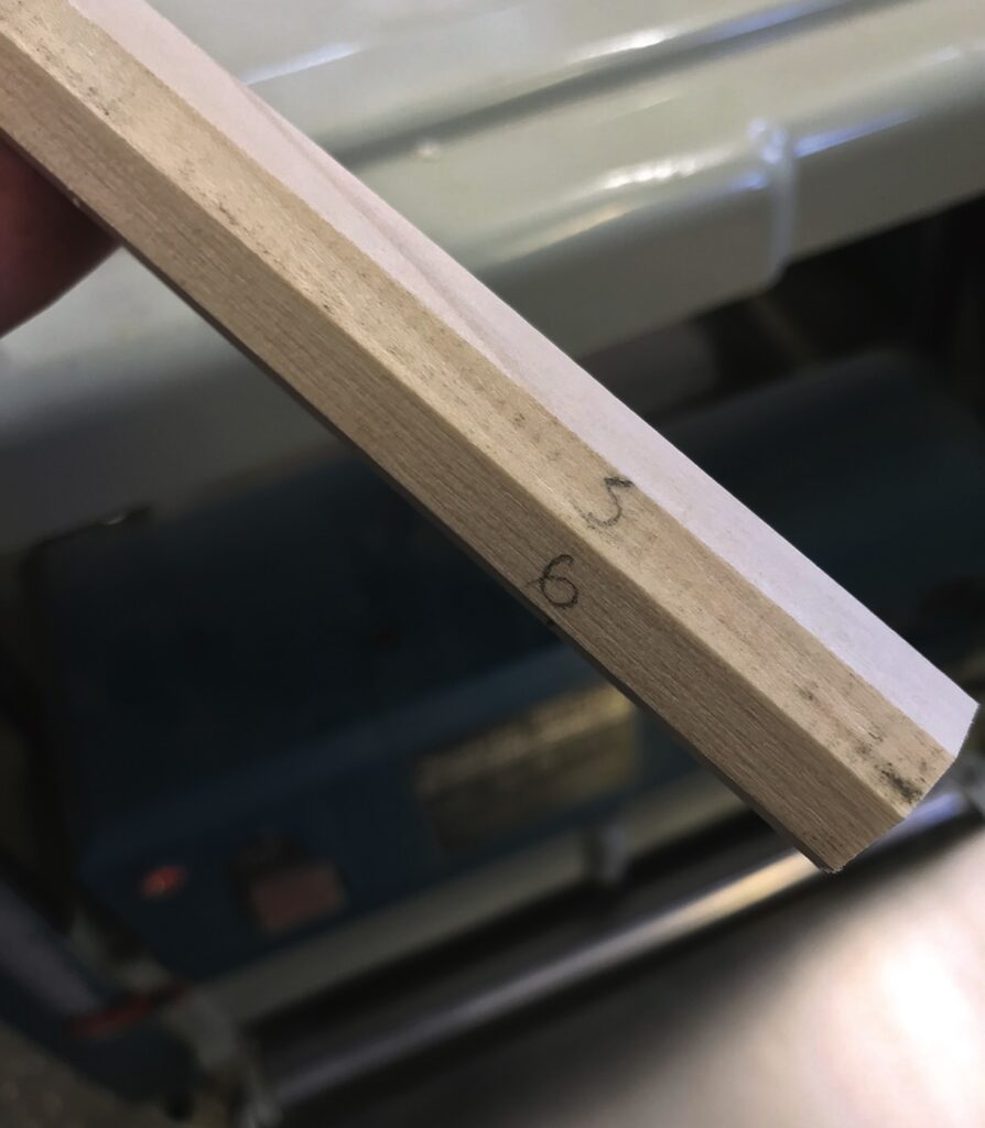 Wooden edge with pencil marks and numbers