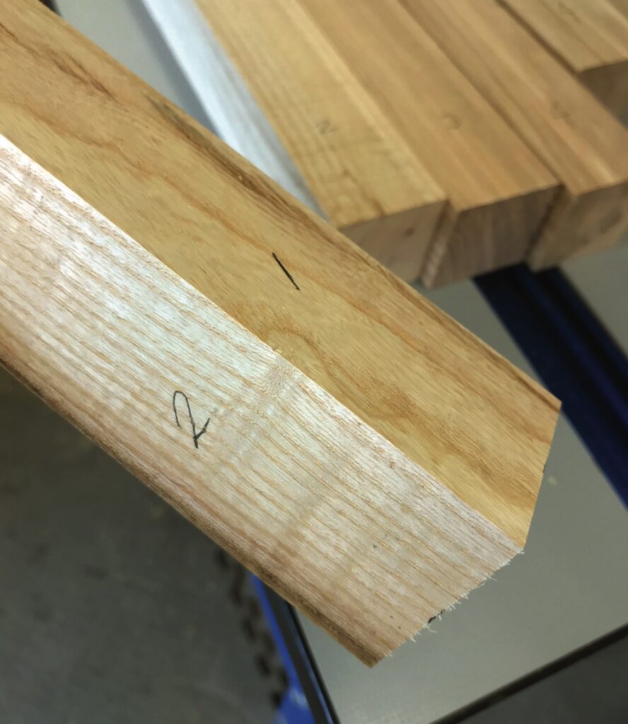 Close-up of wooden miter joint on table saw.