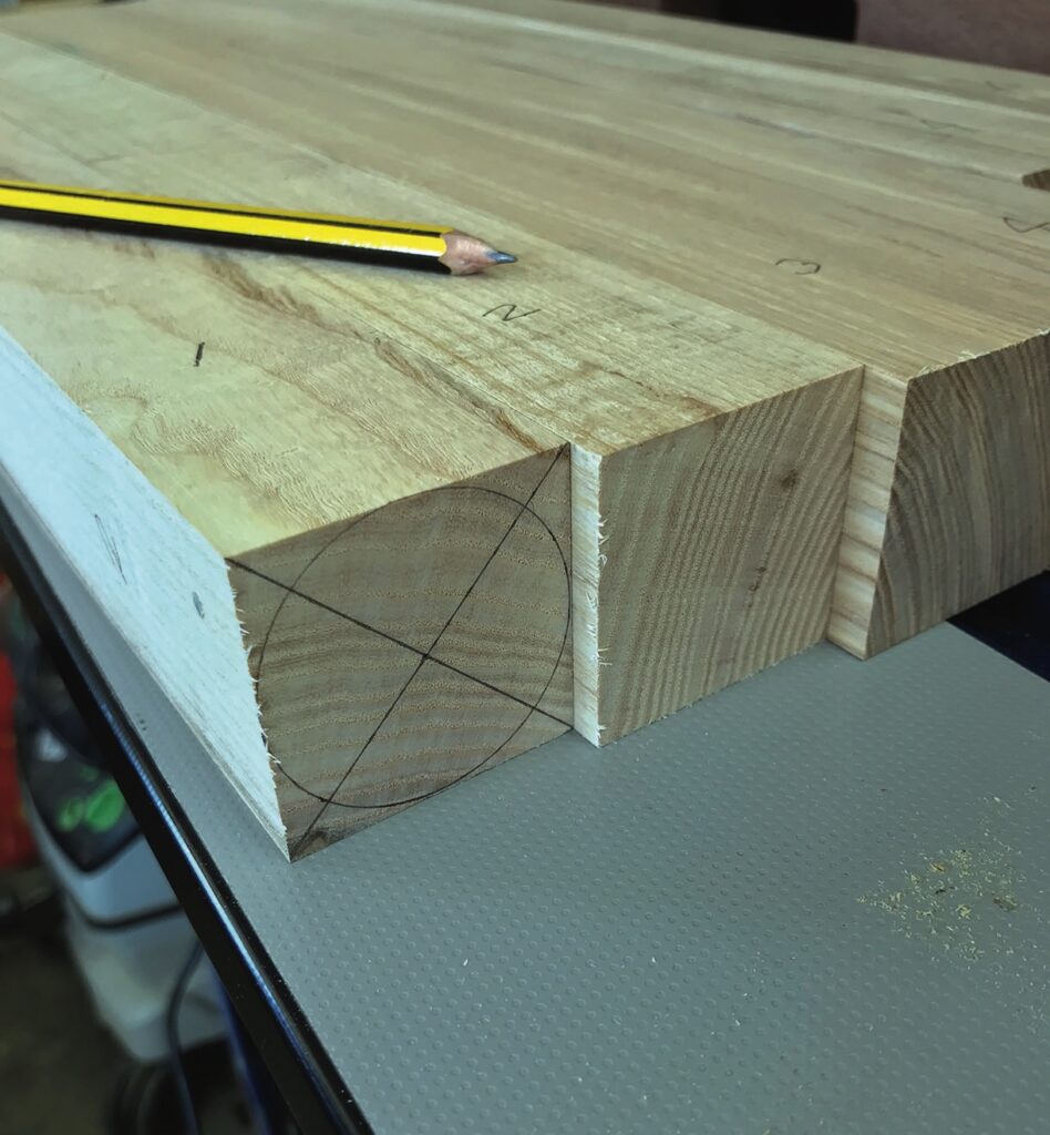 Wooden planks with pencil and circle markings.