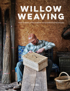 Man weaving willow basket with traditional techniques