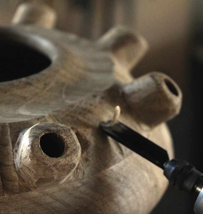 Close-up of wood carving with chisel.