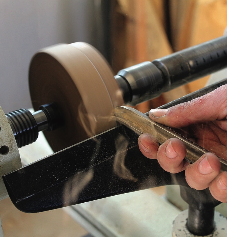 Person using lathe for woodworking precision.