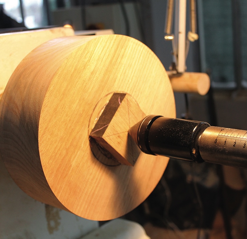 Wood turning on a lathe in workshop.