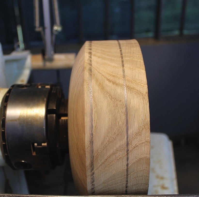 Wood bowl in progress on lathe machine.