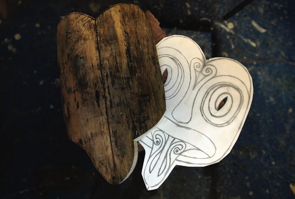 Wooden and paper mask with stylised facial design