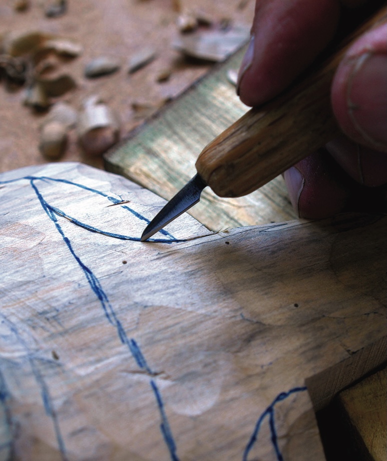 Hand carving marked wood with a chisel