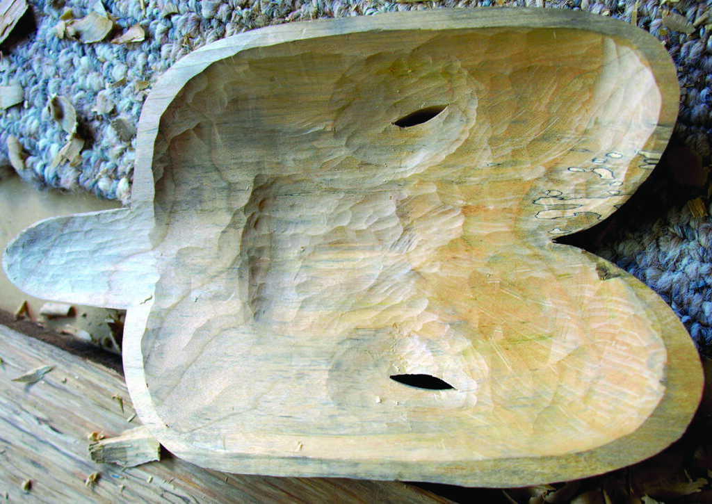 Hand-carved unfinished wooden bird-shaped sculpture