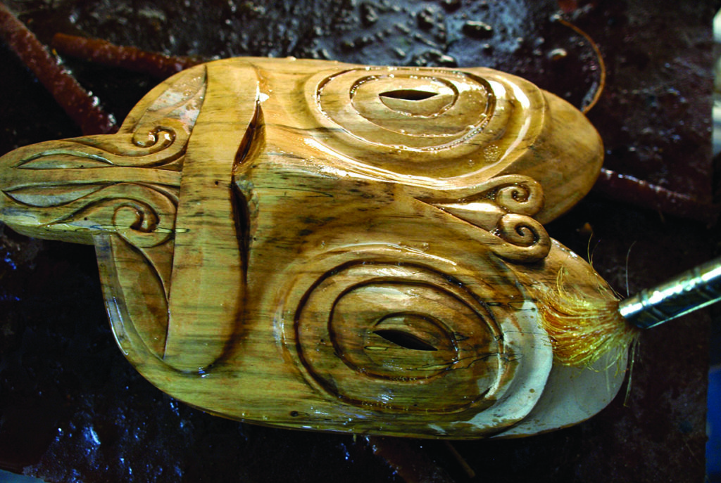 Waterlogged carved wooden mask with spiral eye details