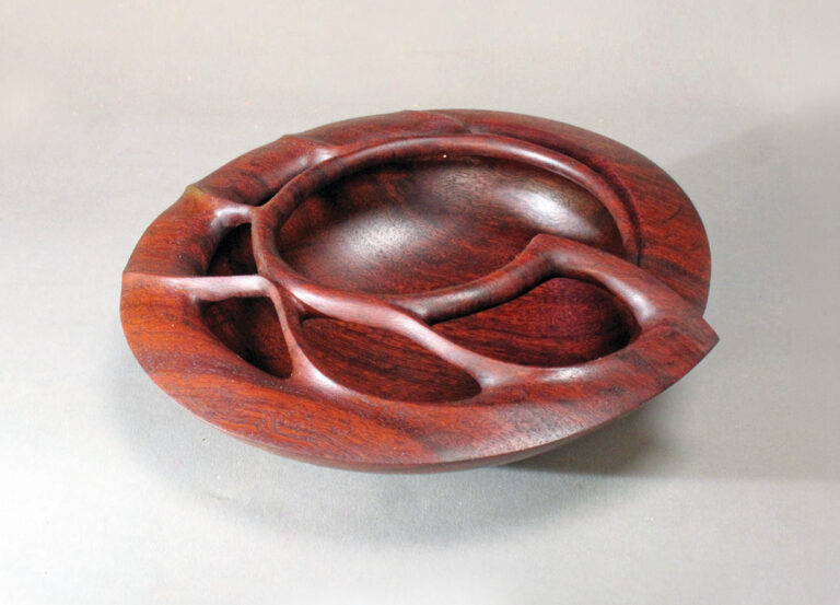 Carved wooden sculpture in rich brown tones.