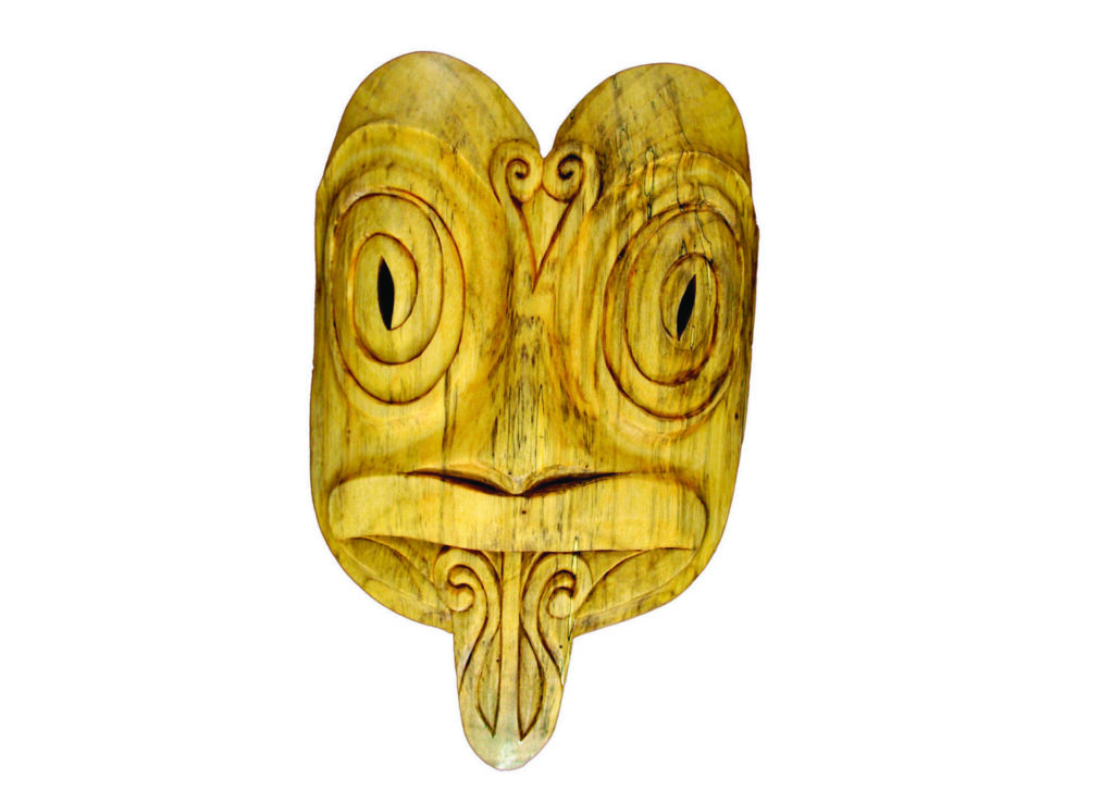 Carved wooden mask with spiral eyes and long nose