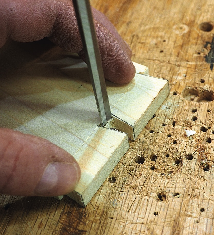 Craftsperson chiselling a notch in a wooden joint