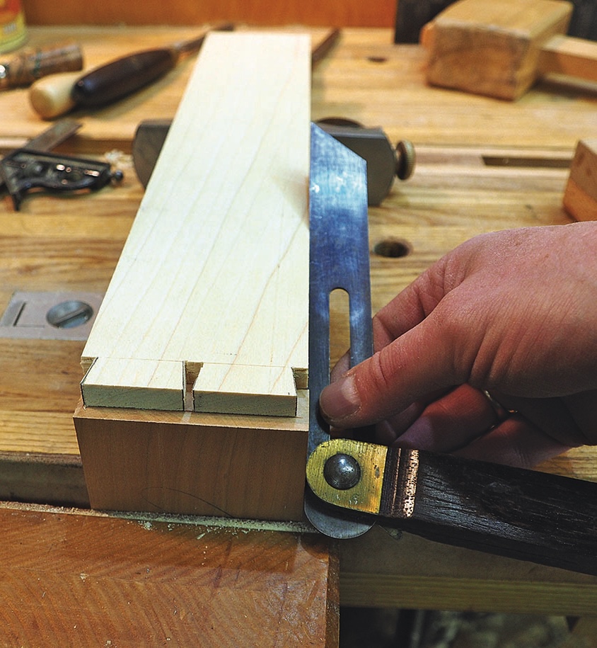Woodworker marks dovetail joints using a sliding bevel