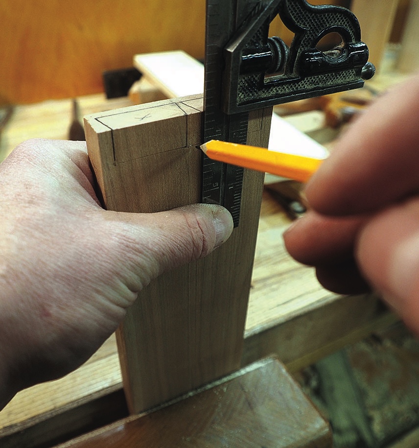 Woodworker marking a timber joint with combination square