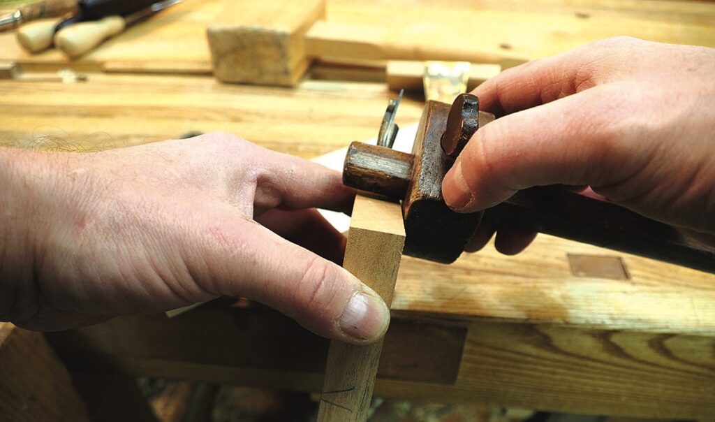 Woodworker shaving timber with a hand plane