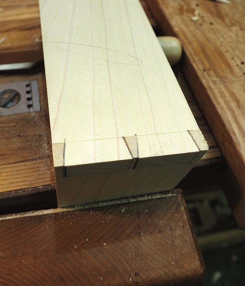 Marked timber joint held in a woodworking vice