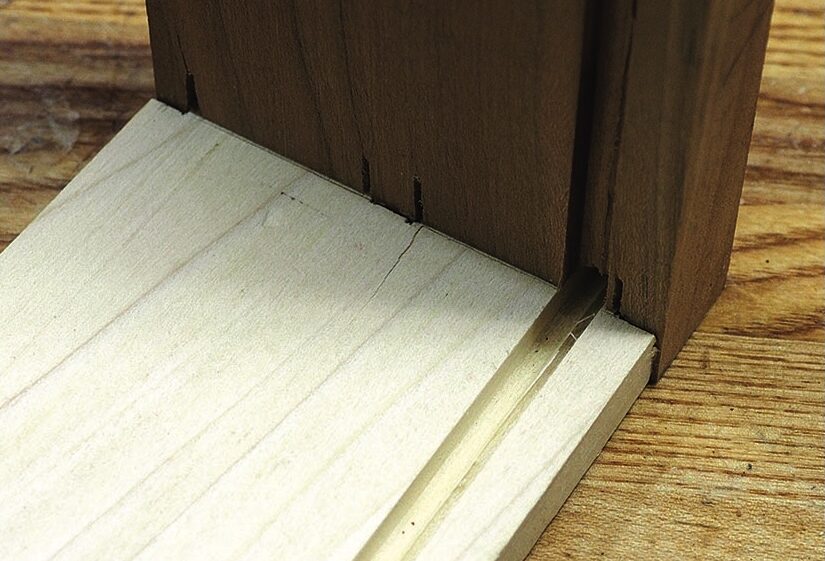 Close-up of wooden door frame and threshold joint