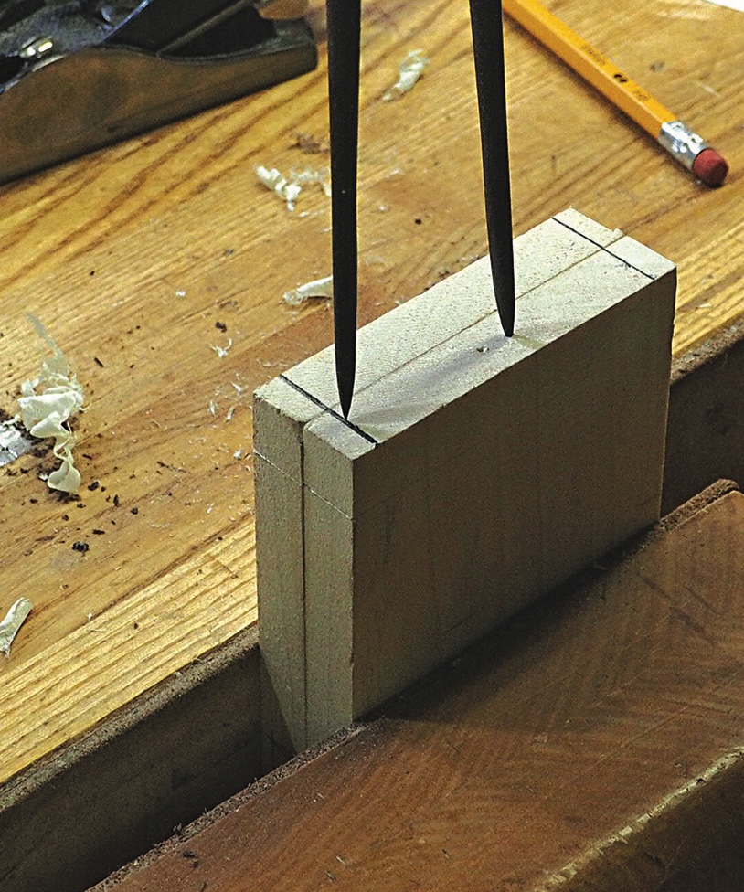Compass marking dovetail lines on a wooden block