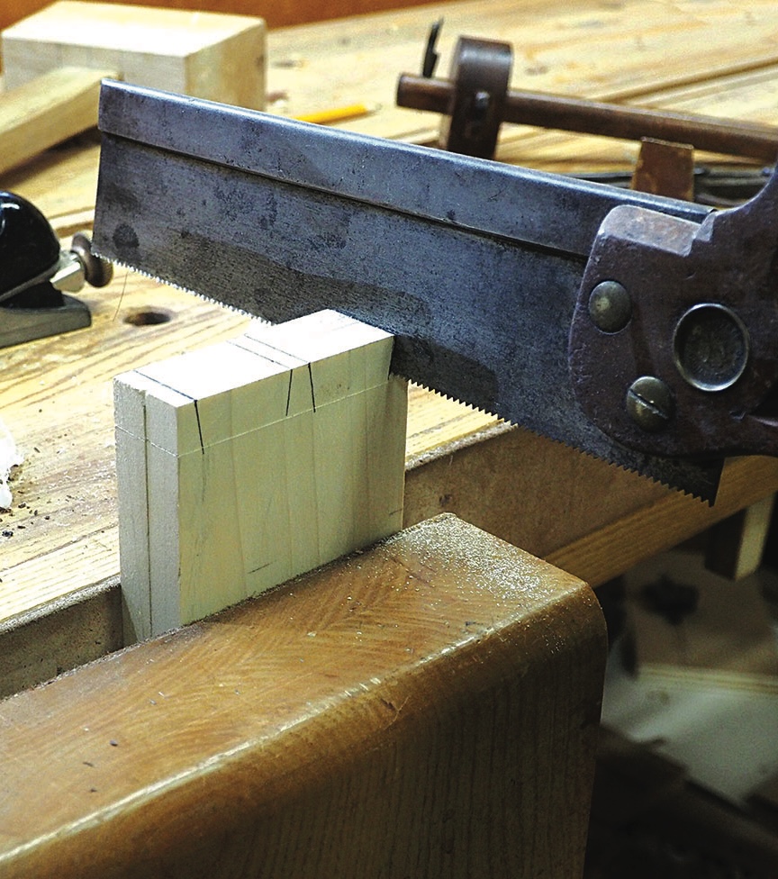 Tenon saw cutting marked timber held in a workbench vice