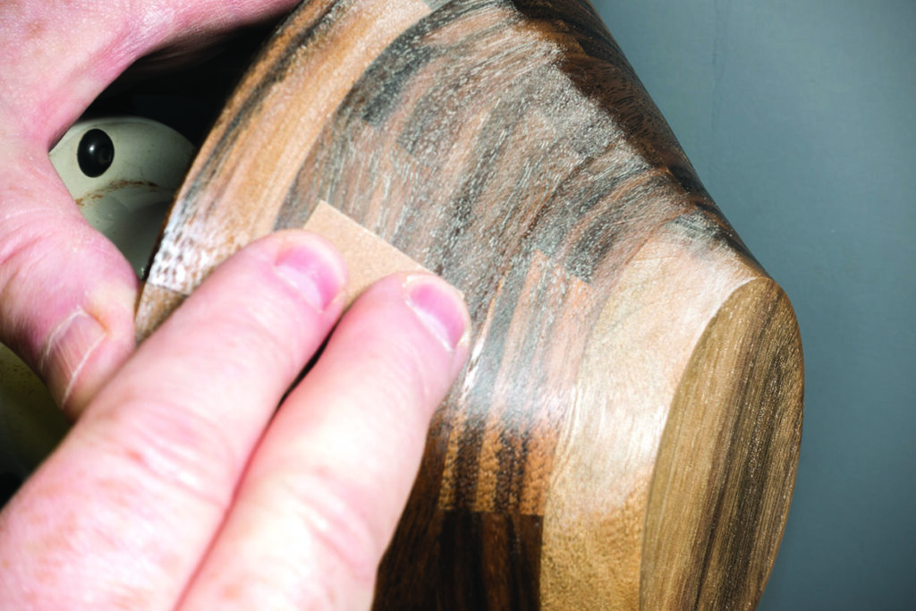 Hand sanding a wooden surface